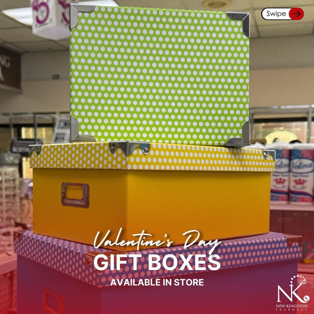 Stack of decorative patterned gift boxes in green, gold, and red, displayed in-store
