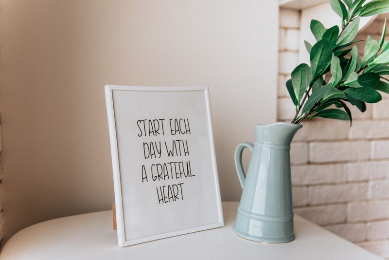 Framed inspirational quote plaque reading "Start each day with a grateful heart"